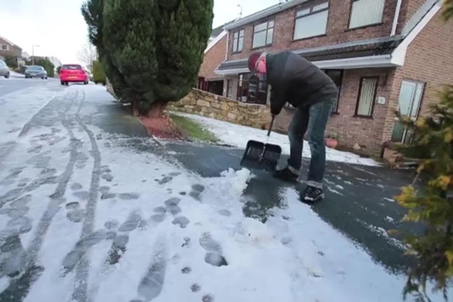 kingways winter tyres man shovelling snow from his driveway